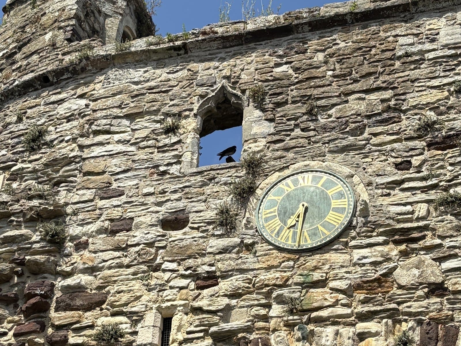 The clock on the stone wall of the Landgate