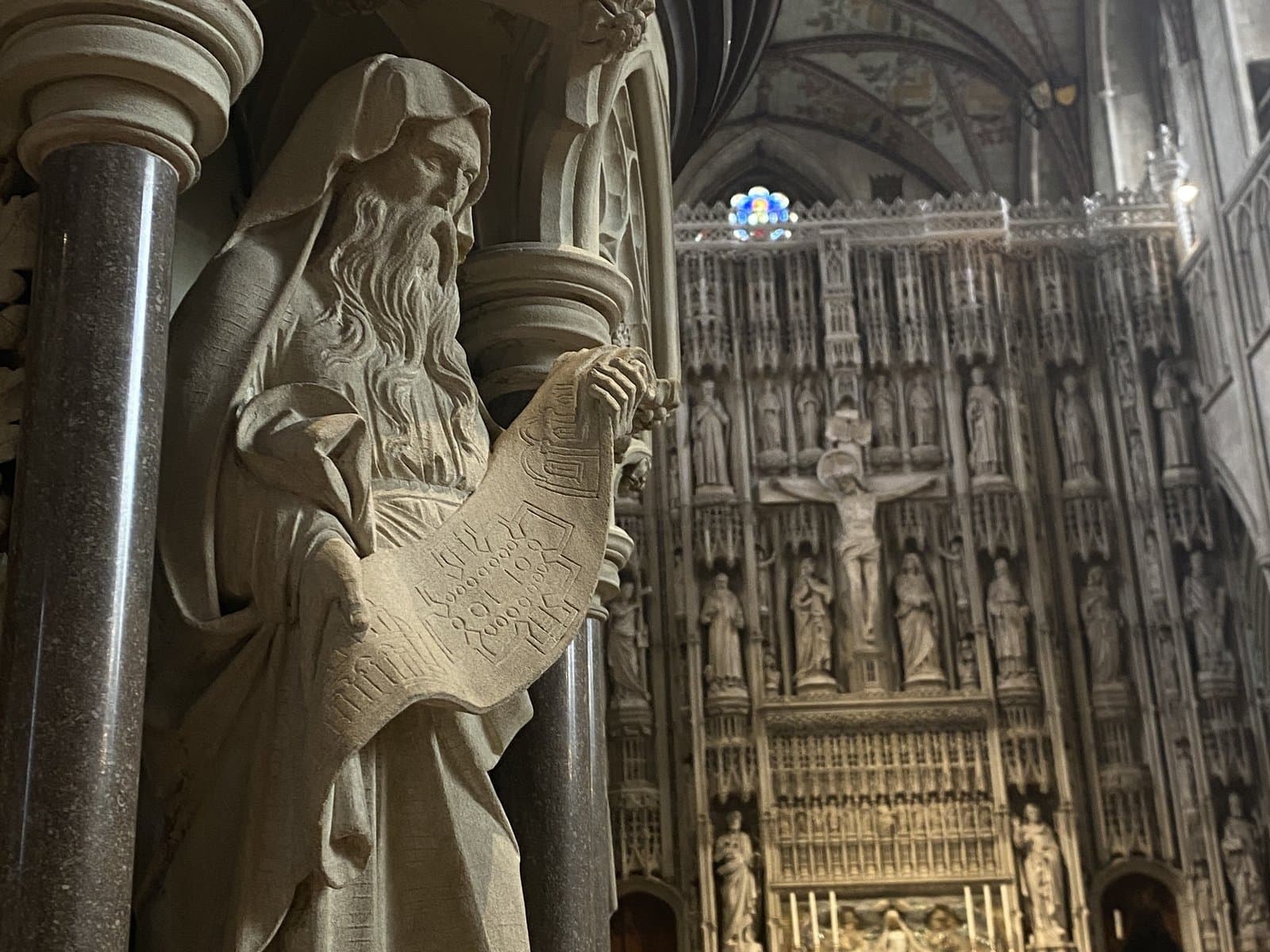 A carved figure and the altar screen inside the cathedral