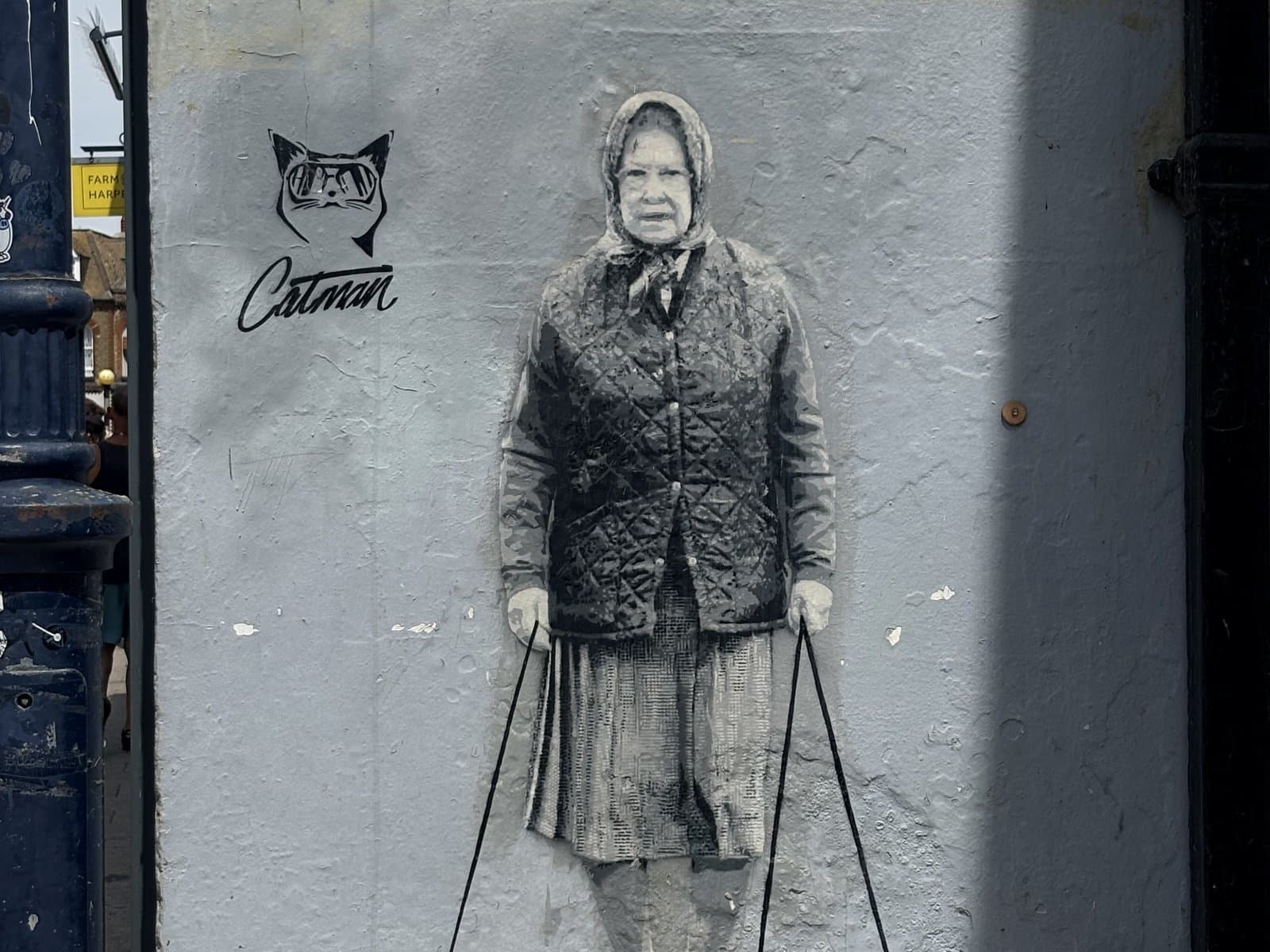 Street art of the Queen walking her corgis